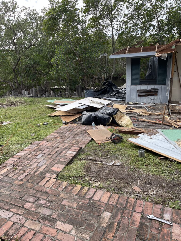 Wood outbuilding dismantling in progress.